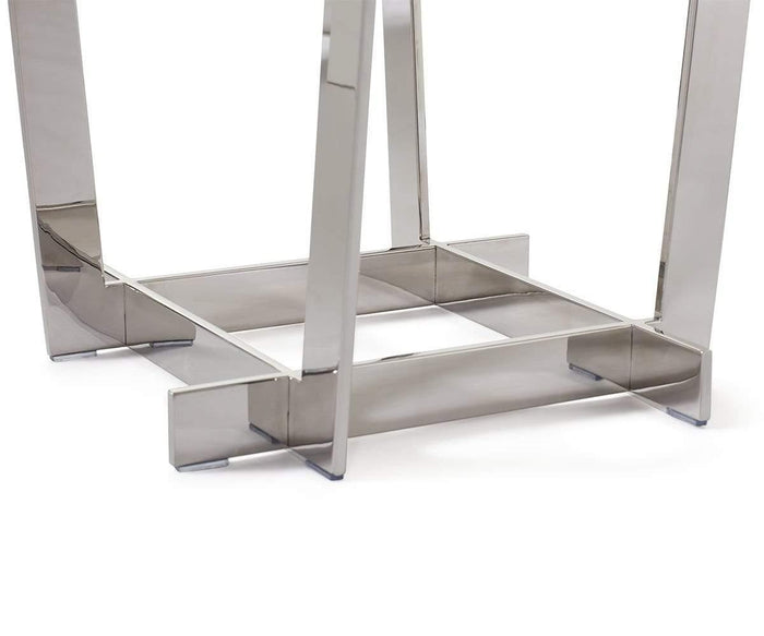 The Sieva End Table features shiny stainless steel legs with a rectangular base frame, standing on a white surface to create the perfect foundation for a modern end table. The high-gloss finish of the legs adds a sleek touch that elevates any contemporary space.