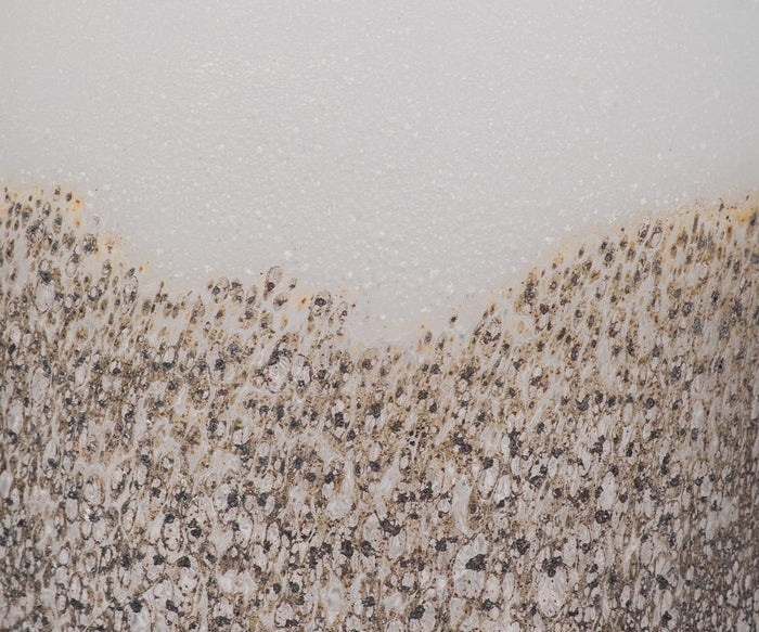 Close-up of the Slate Ombre Vase reveals its textured and abstract surface, where dark specks and subtle gradients blend together, creating a pattern reminiscent of contemporary decor.