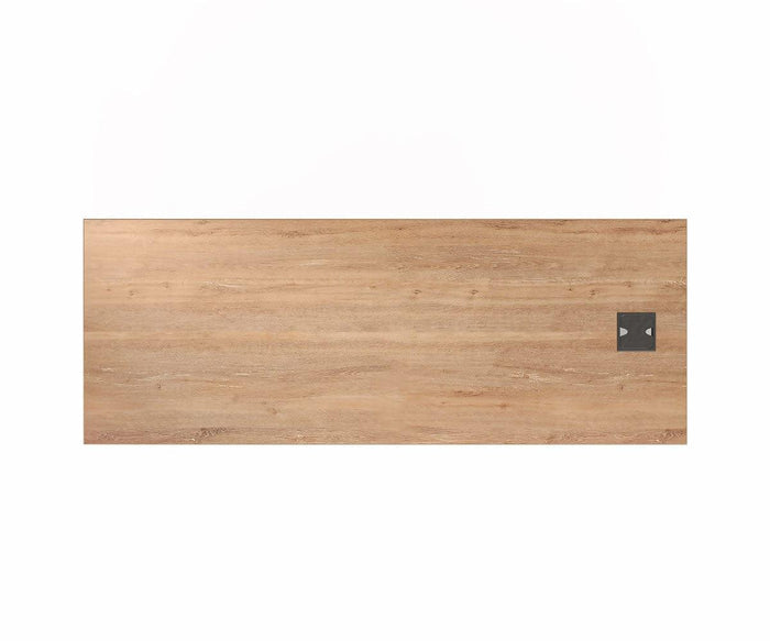 The Slater 63″ Desk features a rectangular wooden tabletop with a light brown wood grain veneer finish and includes a small black square panel with two buttons near the edge, all set against a white background—blending contemporary style and functionality for your workspace.
