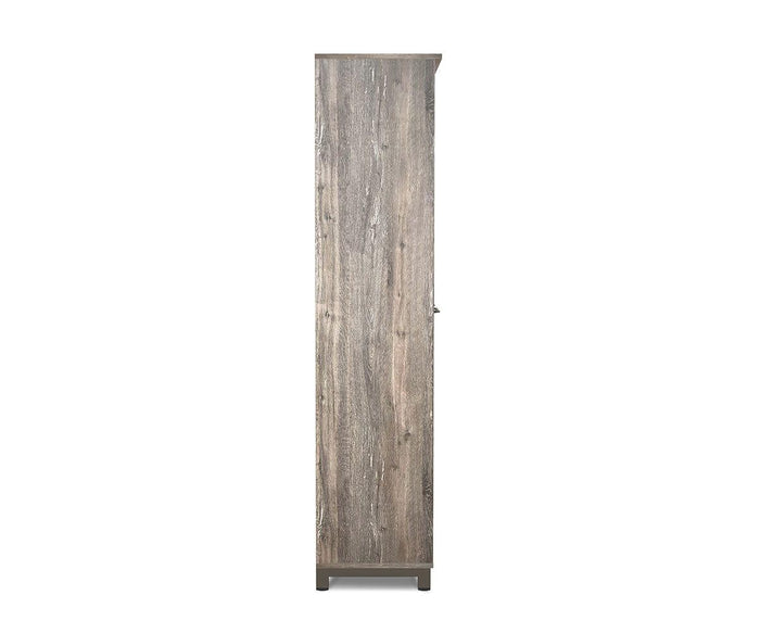 The Slater High Cabinet With Doors features a tall wooden frame with a weathered gray-brown finish, displayed here in a side view. It stands on short legs with both top and bottom edges flat, while the subtle wood grain from the Slater Collection lends distinctive character to the high cabinet. From this angle, no handles or additional details are visible.