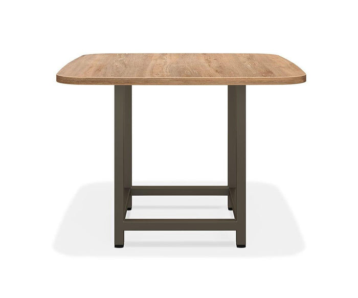 The Slater Square Meeting Table features an Oak Driftwood rectangular top with rounded corners, supported by a sturdy metal frame in a simple, modern design, and is shown against a plain white background.