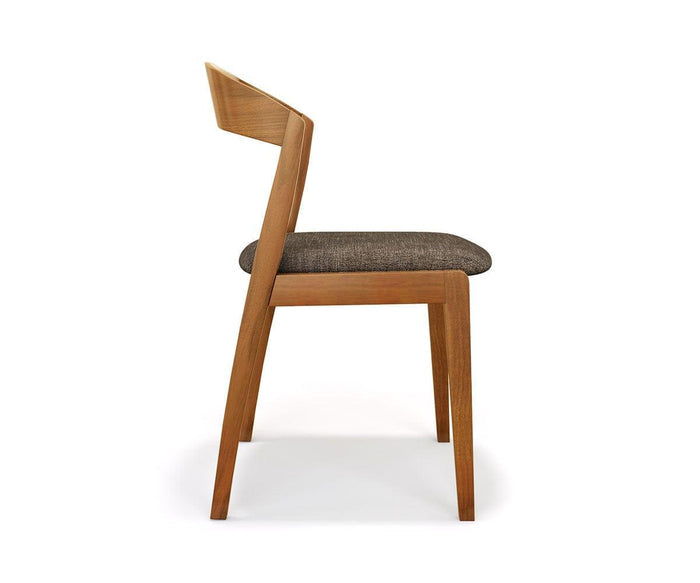 Side view of the Soro Dining Chair, featuring a modern mid-century design with a slightly angled backrest and a dark cushioned seat, photographed against a plain white background.