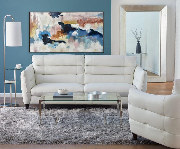 Modern living room with white sofas, a glass coffee table, a gray shag rug, a floor lamp, and contemporary decor including the Spring Valley Oil Painting and a large mirror reflecting a vase with branches.