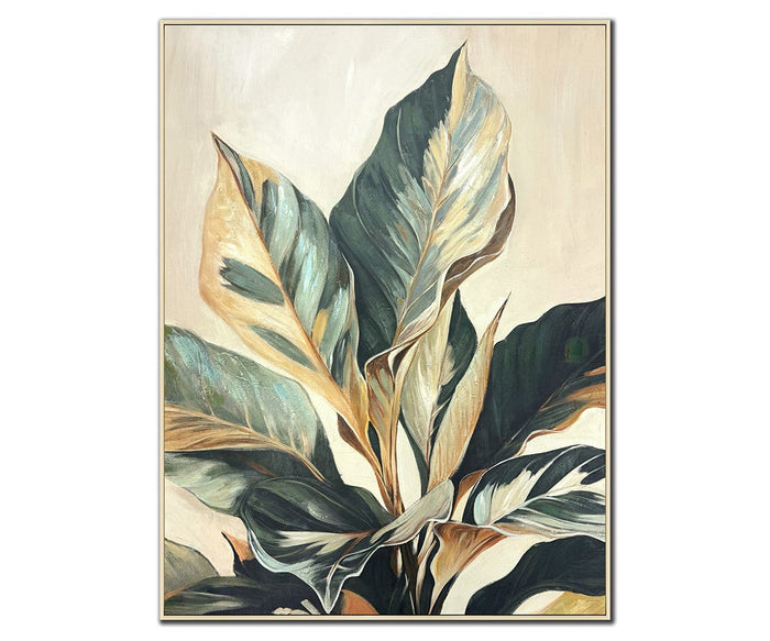 The Sunlit Fronds Wall Art features large green leaves with cream and tan highlights set against a light beige background, elegantly framed with a thin gold border. This multi-colored botanical piece brings nature-inspired sophistication to your space.