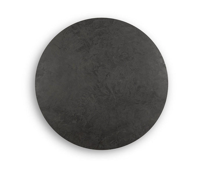 The Taavi 20″ Round End Table, with its large, flat, round silhouette in dark gray stone or concrete, evokes a mid-century modern aesthetic set against a plain white background.