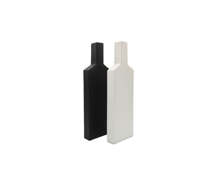 Two minimalist, rectangular Tall Silhouette Vases—shaped like bottles and reminiscent of contemporary sculpture—stand upright side by side against a plain white background, one in black and one in white.