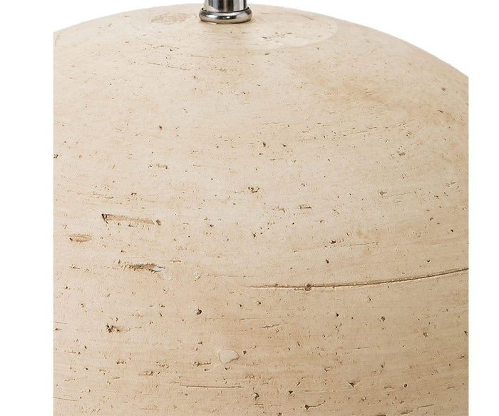 A close-up view of the beige, textured stone surface of the Textured Clay Lamp shows subtle natural lines and small holes, with a small metallic piece from the lamp visible at the top against a white background.