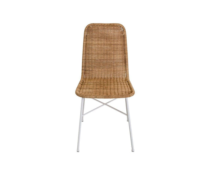 The Tori Dining Chair, shown in natural wicker with a woven seat and backrest and slim white metal legs, features a simple modern design and is set against a plain white background.
