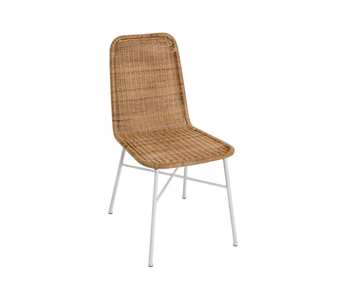 The Tori Dining Chair showcases a Scandinavian-inspired design with a rattan woven seat and backrest, slender white metal legs, and a simple, modern silhouette, all presented against a plain white background.