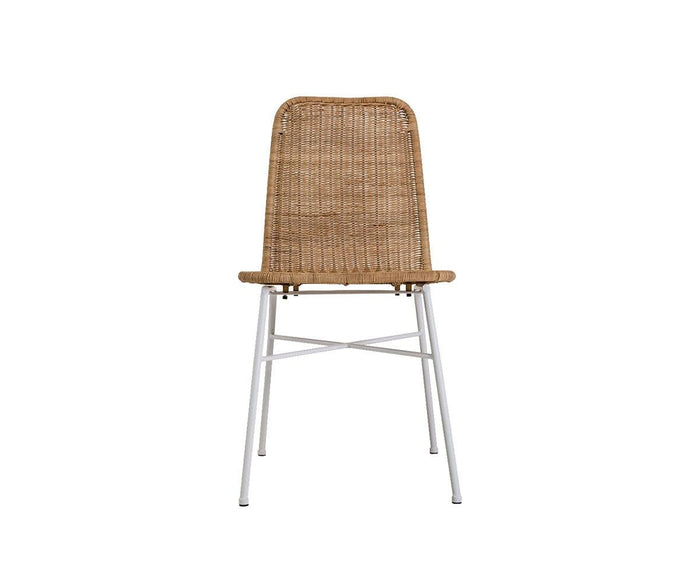 A front-facing view of the Tori Dining Chair, featuring a woven rattan backrest and seat with four slender white metal legs and crossbar supports.