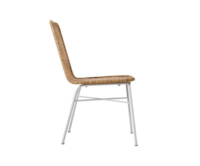 Side view of the Tori Dining Chair, featuring a light brown woven seat and backrest supported by thin white metal legs, set against a plain white background.