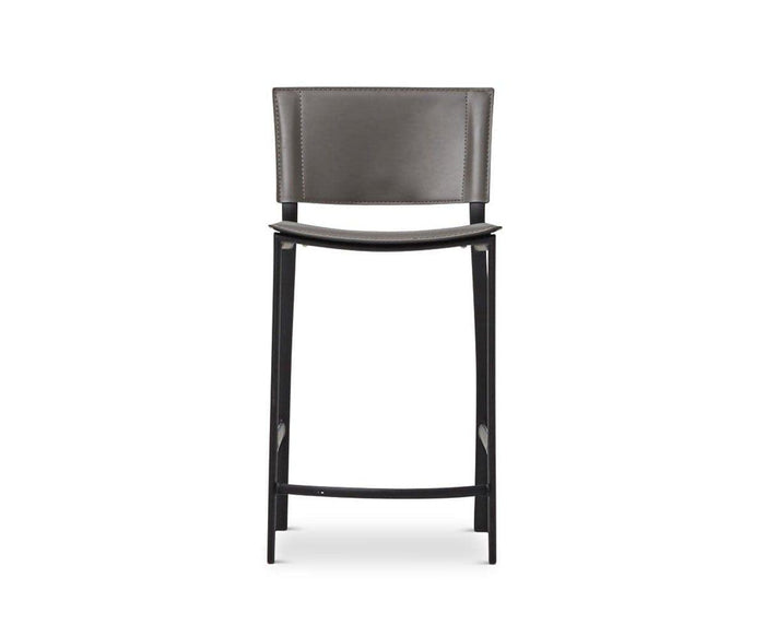 The Torren Counter Stool features a grey cushioned backrest and seat, supported by sleek black wooden legs and a convenient footrest. Its modern design showcases clean lines and a subtly curved seat, making this upholstered counter stool a stylish choice for any contemporary setting.