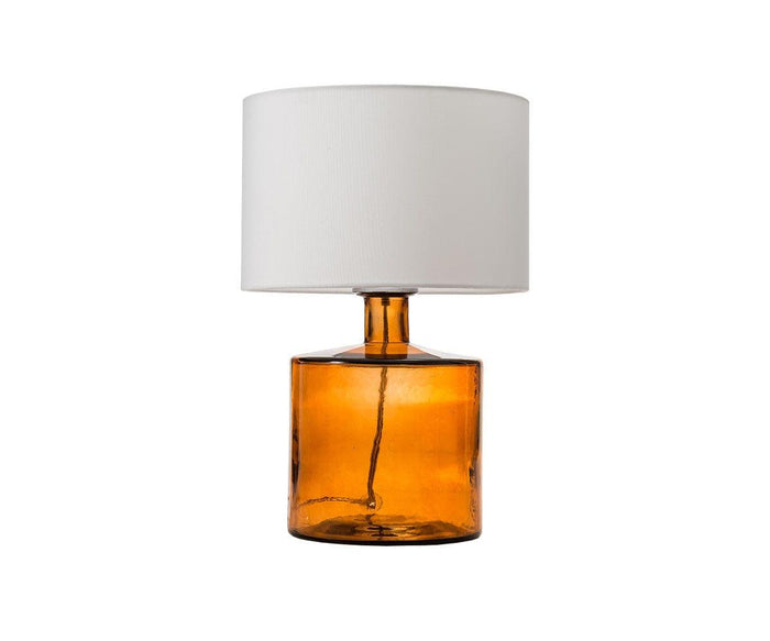 The Translucent Glass Lamp - Amber features a cylindrical amber recycled glass base and a plain white fabric shade, set against a white background.