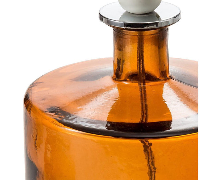 Close-up of the neck and top section of the Translucent Glass Lamp - Amber, featuring a round amber glass body with a silver and white stopper.