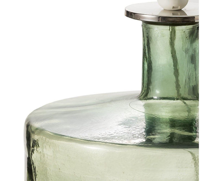 A close-up of the Translucent Glass Lamp in Smokey Grey showcases its narrow neck, textured glass surface, and a subtle reflective sheen reminiscent of recycled glass bottles.