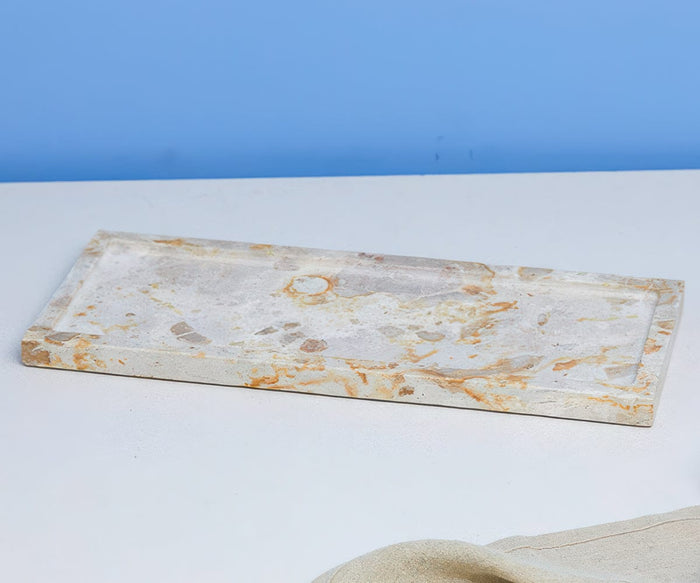 The Tula Rectangle Marble Tray, a handcrafted serveware piece in a white/multi colorway, features an elegant marbled pattern and sits gracefully on a white surface against a light blue background.