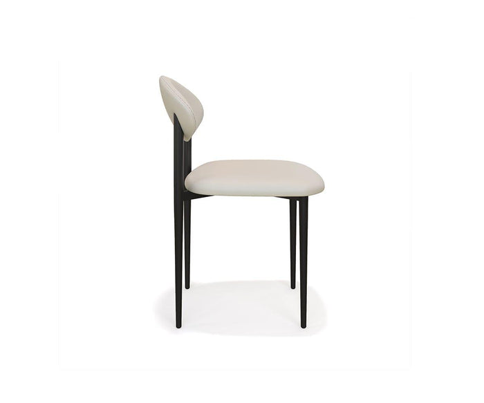 The Turi Dining Chair features a modern design with a white cushioned seat and backrest, supported by a sleek black metal frame with slim legs and minimalist lines, shown from the side against a plain white background.