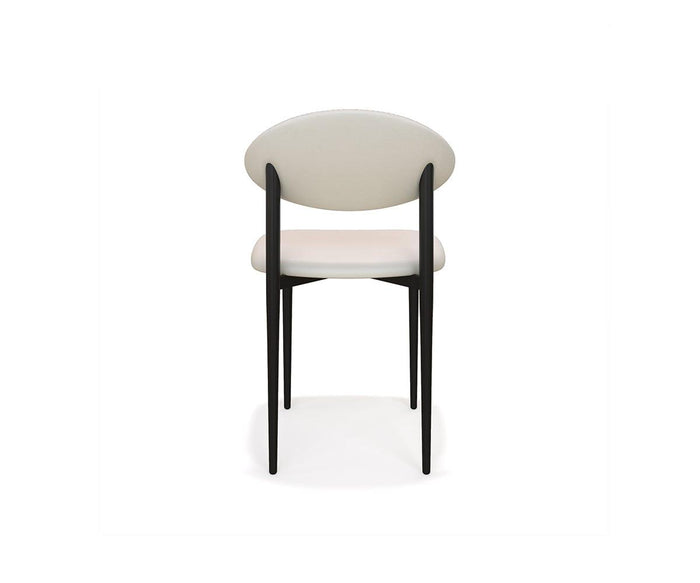 The Turi Dining Chair features a modern design with a round white backrest and a cushioned seat, supported by four slender black metal frame legs, shown against a plain white background and viewed directly from the back.
