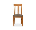 The Vackra Dining Chair, shown from the front against a white background, is a modern dining chair crafted from solid beech wood in a cherry finish, featuring a cushioned seat and vertical slats on the backrest.