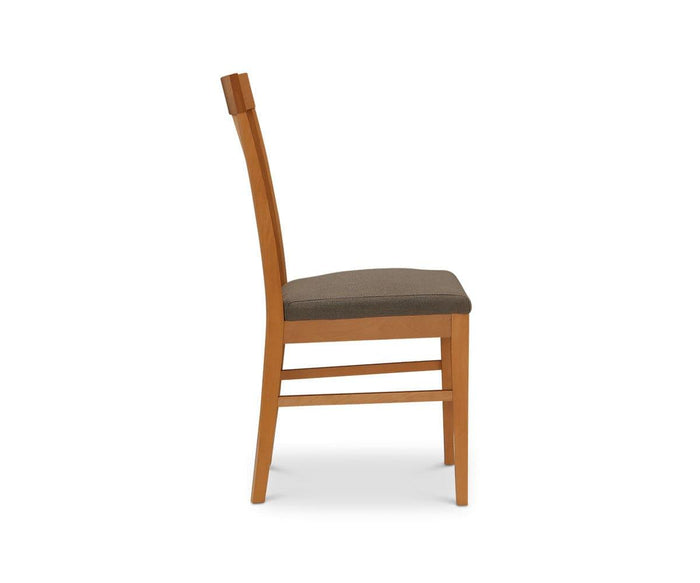 Side view of the Vackra Dining Chair, a contemporary chair made of solid beech wood featuring a straight backrest and a dark upholstered seat, displayed against a plain white background.