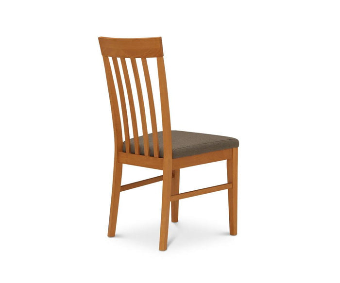 The Vackra Dining Chair, expertly constructed from solid beech wood, showcases vertical backrest slats and a dark-hued cushioned seat. Pictured at an angle against a white background, this modern chair perfectly blends elegance and comfort—a sophisticated addition to any contemporary dining area.