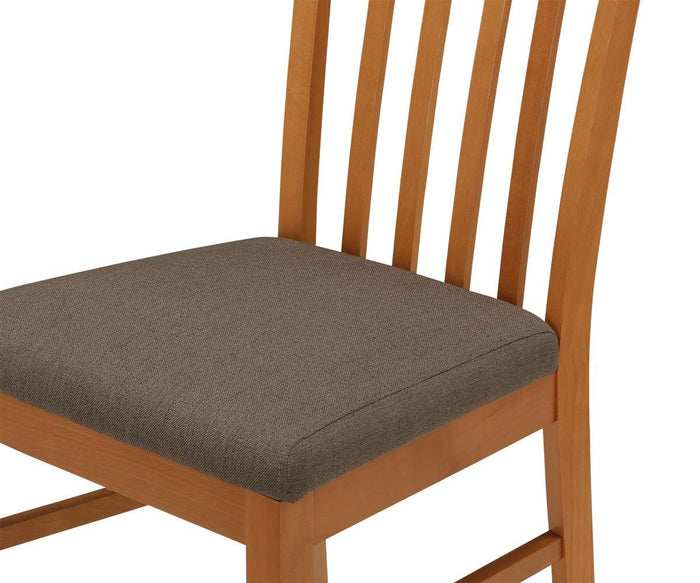 A close-up of the Vackra Dining Chair showcases its solid beech wood frame, a padded seat upholstered in gray fabric, and a slatted backrest. The Vackra Dining Chair blends comfort with contemporary design for a modern dining experience.