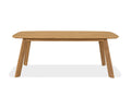 The Vinicio Outdoor Dining Table, shown in natural teak against a white background, features a rectangular wooden top with rounded edges and four angled legs. Its simple, modern design makes it an ideal choice for contemporary outdoor spaces.