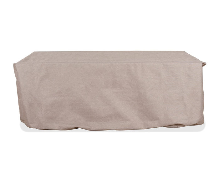 A rectangular table covered with a loose, A02 Cream Vinna Dining Table Cover against a white background—an all-season, water-resistant solution designed for year-round durability.