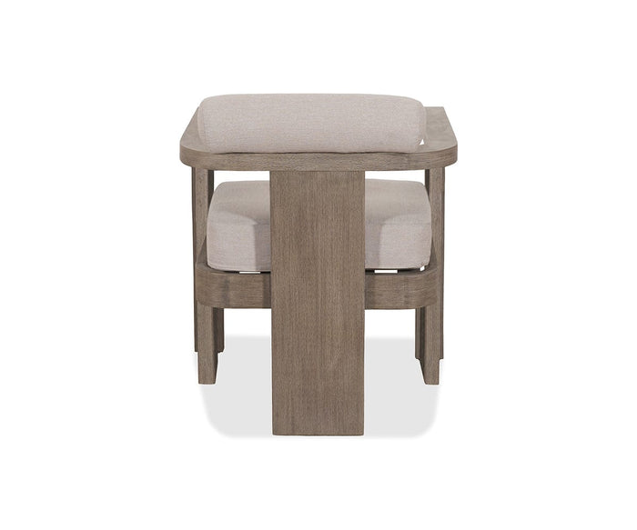 The Vinna Outdoor Dining Chair showcases a contemporary wooden design with light beige cushions, seen from the front and characterized by a central solid vertical support and open rectangular armrests. Its use of weather-resistant materials ensures durability, making it a stylish and practical option for modern outdoor dining spaces.