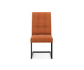 The West Dining Chair features a modern design with a pumpkin-colored velvet cushioned seat and backrest, tufted details, and black metal legs, displayed against a plain white background.