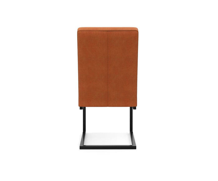 The West Dining Chair features a contemporary cantilever design with a brown upholstered backrest and a black metal base, shown from the back against a plain white background.