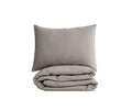 A neatly folded Woven Waffle Duvet Cover + Sham Set in Light Grey, crafted from soft cotton flax and inspired by minimalist Scandinavian bedding, with the matching sham placed in front—all displayed against a plain white background.